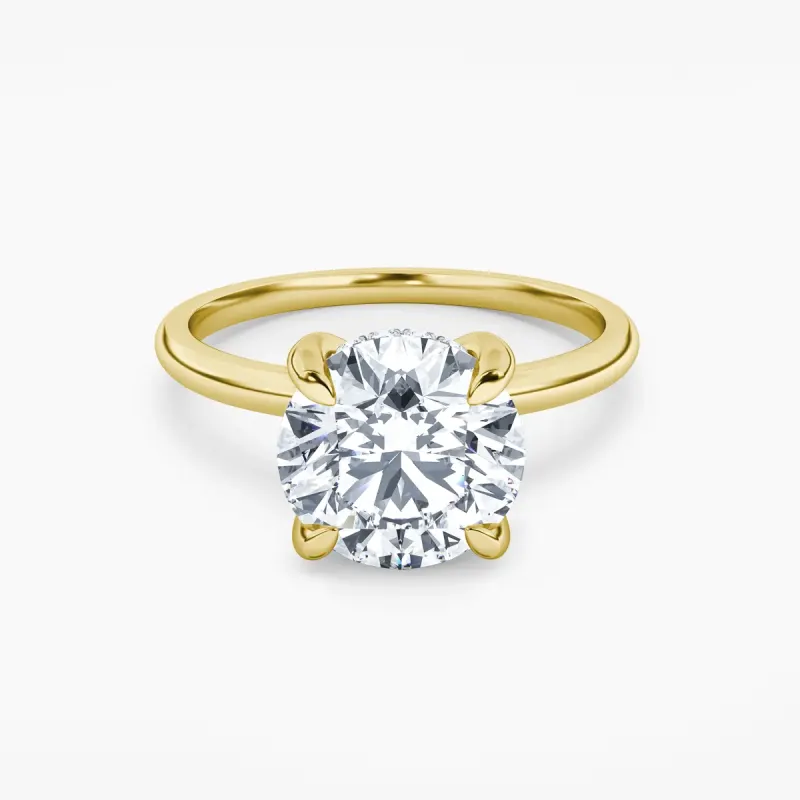 Whispering Halo with a round diamond in 18k yellow gold